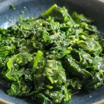 ['Close-up of freshly cooked air fryer spinach with a bright green color and a glossy finish.', 'Side view of air fryer spinach highlighting its juicy texture and vibrant hue.', 'Detailed image of sautéed spinach from an air fryer, showcasing garlic seasoning.', 'Close-up shot of air fryer spinach, emphasizing the buttery sheen and seasoning.']
