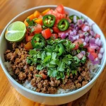 ['Close-up view of a Healthy Ground Beef Bowl with colorful ingredients and garnishes.', 'Side view of a hearty Healthy Ground Beef Bowl featuring ground beef and vibrant vegetables.', 'A detailed look at a Healthy Ground Beef Bowl filled with fresh ingredients and seasonings.', 'Juicy Healthy Ground Beef Bowl showcasing ground meat, sweet potatoes, and diced veggies.']