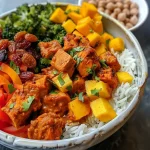 ['A close-up side view of a Masala Turkey Buddha Bowl featuring diced turkey, colorful roasted vegetables, and cooked rice.', 'A detailed shot of a Buddha bowl filled with Masala turkey, roasted veggies, and a mango chutney garnish.', 'A vibrant Masala Turkey Buddha Bowl served with mango and golden raisin chutney on a rustic plate.', 'A delicious Buddha bowl with turkey, basmati rice, and assorted vegetables, highlighting the chutney on top.']