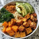 ['Close-up view of a colorful Sweet Potato Vegan Buddha Bowl filled with various fresh ingredients.', 'Side view of a vibrant Sweet Potato Vegan Buddha Bowl showcasing sweet potatoes, greens, and grains.', 'Detailed image of a Sweet Potato Vegan Buddha Bowl featuring cubed sweet potatoes, avocado, and tofu.', 'Artistic presentation of a Sweet Potato Vegan Buddha Bowl with kale, couscous, and tahini dressing.']