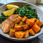 ['A close-up side view of a baked salmon sweet potato bowl with vibrant colors and fresh ingredients.', 'Juicy baked salmon fillets served over roasted sweet potatoes with greens and lemon wedges.', 'A delicious bowl featuring crispy-skinned salmon, sweet potatoes, and a sprinkle of fresh herbs.', 'A colorful meal containing salmon, sweet potatoes, greens, and garnished with lemon, captured in detail.']