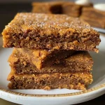Close-up shot of freshly baked gingerbread bars with cream cheese frosting.