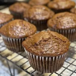 Side view of freshly baked gingerbread muffins with a golden-brown crust.