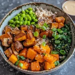 Close-up view of a Roasted Garlic Buddha Bowl featuring vibrant vegetables and grains.